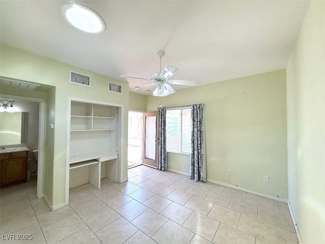 unfurnished bedroom with light tile patterned flooring, baseboards, visible vents, and a closet