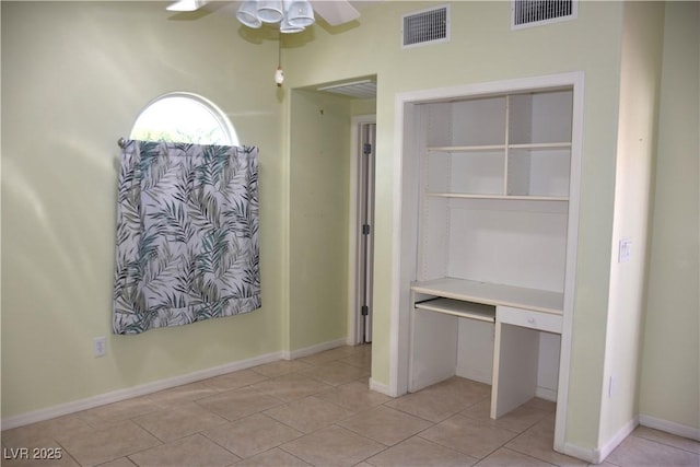 unfurnished bedroom with light tile patterned floors, baseboards, and visible vents