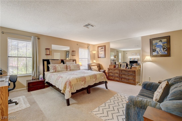 611 Spyglass Ln, Las Vegas, NV 89107 - bedroom featuring visible vents, a textured ceiling, and light carpet