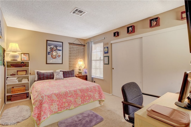 611 Spyglass Ln, Las Vegas, NV 89107 - bedroom with visible vents, a textured ceiling, a closet, and light colored carpet