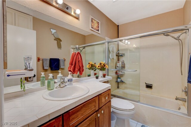 611 Spyglass Ln, Las Vegas, NV 89107 - full bathroom featuring vanity, tile patterned flooring, toilet, and shower / bath combination with glass door