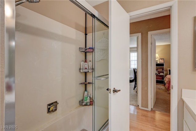 611 Spyglass Ln, Las Vegas, NV 89107 - bathroom with combined bath / shower with glass door and wood finished floors
