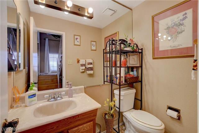 611 Spyglass Ln, Las Vegas, NV 89107 - half bathroom featuring visible vents, toilet, and vanity