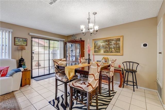 611 Spyglass Ln, Las Vegas, NV 89107 - dining room with light tile patterned floors, visible vents, a textured ceiling, and a chandelier