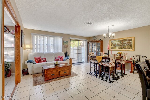 611 Spyglass Ln, Las Vegas, NV 89107 - living area with light tile patterned flooring, a textured ceiling, a chandelier, and visible vents
