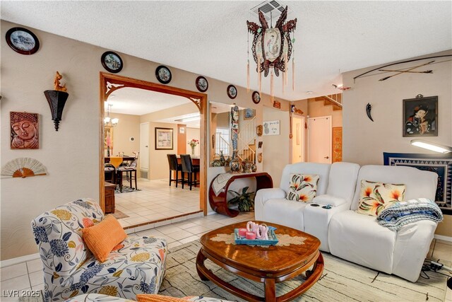 611 Spyglass Ln, Las Vegas, NV 89107 - tiled living room featuring a textured ceiling, an inviting chandelier, and visible vents