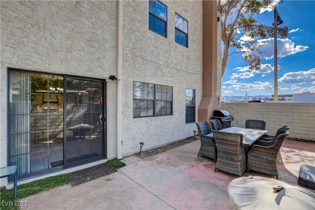 611 Spyglass Ln, Las Vegas, NV 89107 - view of patio with outdoor dining area, fence, and a grill