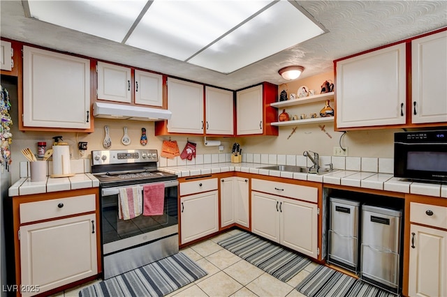 611 Spyglass Ln, Las Vegas, NV 89107 - kitchen featuring tile countertops, light tile patterned floors, a sink, stainless steel electric stove, and under cabinet range hood