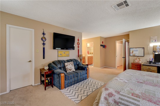 611 Spyglass Ln, Las Vegas, NV 89107 - carpeted bedroom featuring baseboards, connected bathroom, a textured ceiling, and visible vents