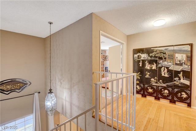 611 Spyglass Ln, Las Vegas, NV 89107 - hall featuring a textured ceiling and an upstairs landing