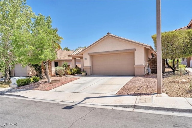 ranch-style house with stucco siding, driveway, a tile roof, and a garage