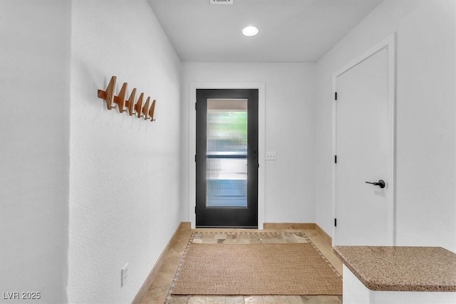 doorway to outside featuring baseboards