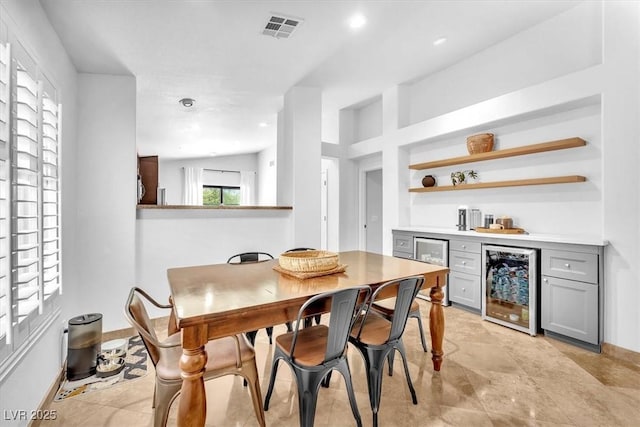 dining area with visible vents, wine cooler, baseboards, recessed lighting, and a bar