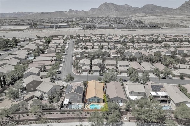 drone / aerial view featuring a residential view and a mountain view