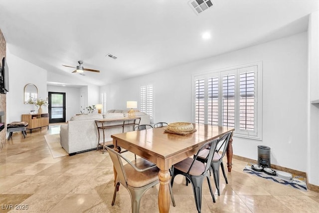 dining area with ceiling fan, visible vents, baseboards, and vaulted ceiling