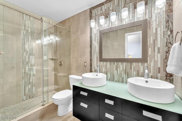 full bath featuring a sink, tile walls, backsplash, and a stall shower