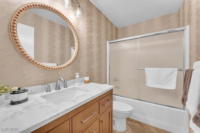 full bath featuring vanity, combined bath / shower with glass door, and wallpapered walls
