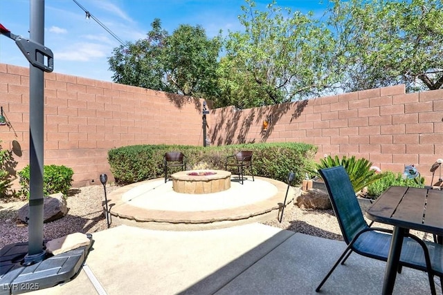 view of patio / terrace with a fenced backyard and a fire pit