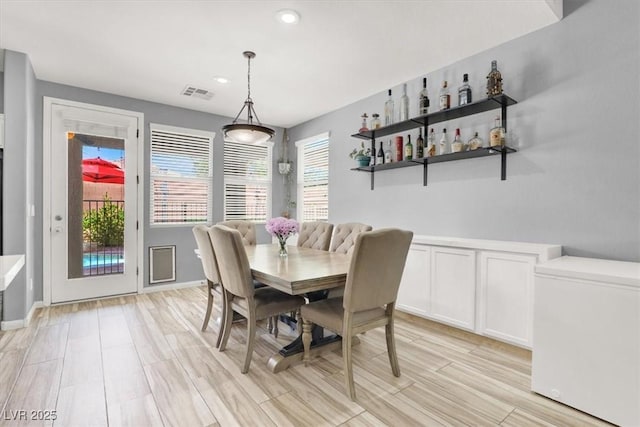 dining area with recessed lighting, visible vents, a healthy amount of sunlight, and light wood-style flooring
