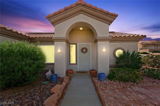 2725 Byron Dr, Las Vegas, NV 89134 - exterior entry at dusk with a tiled roof and stucco siding