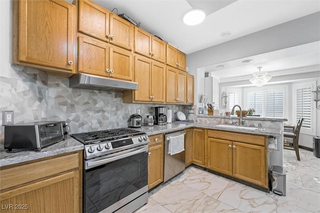 2725 Byron Dr, Las Vegas, NV 89134 - kitchen with appliances with stainless steel finishes, under cabinet range hood, a sink, light marble finish flooring, and a peninsula