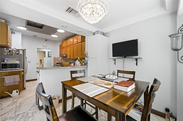 2725 Byron Dr, Las Vegas, NV 89134 - dining space with a chandelier, light marble finish flooring, and baseboards