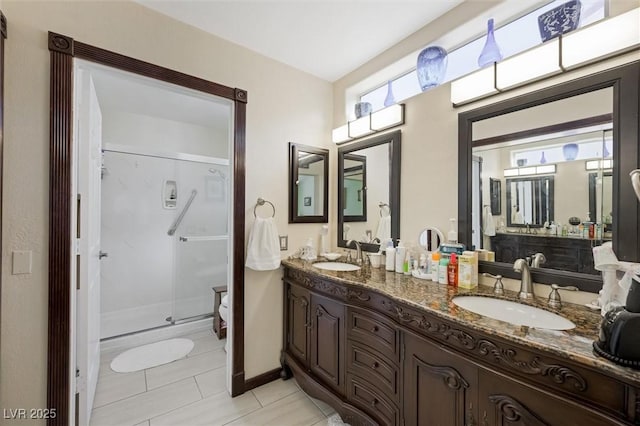 2725 Byron Dr, Las Vegas, NV 89134 - bathroom featuring a stall shower, double vanity, tile patterned floors, and baseboards