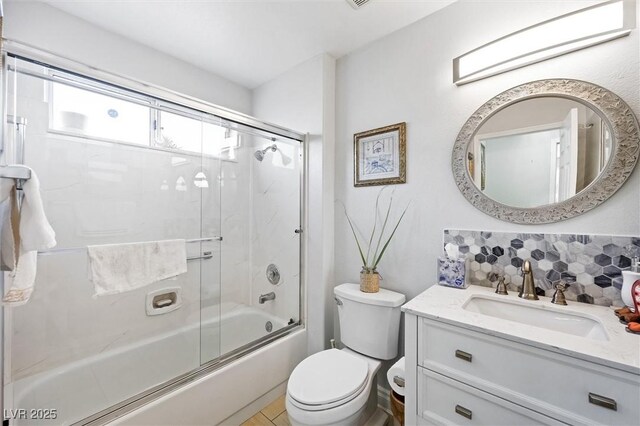2725 Byron Dr, Las Vegas, NV 89134 - full bath featuring combined bath / shower with glass door, vanity, tasteful backsplash, and toilet