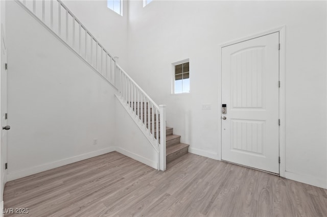 595 Beverly Pine Pl, Henderson, NV 89011 - foyer entrance with stairway, baseboards, light wood-style flooring, and a wealth of natural light