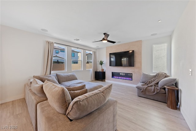 595 Beverly Pine Pl, Henderson, NV 89011 - living area with baseboards, plenty of natural light, and a fireplace