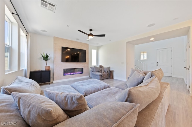 595 Beverly Pine Pl, Henderson, NV 89011 - living area with visible vents, a healthy amount of sunlight, and light wood-style flooring