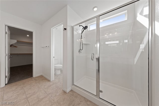 595 Beverly Pine Pl, Henderson, NV 89011 - full bathroom featuring toilet, baseboards, a walk in closet, and a stall shower