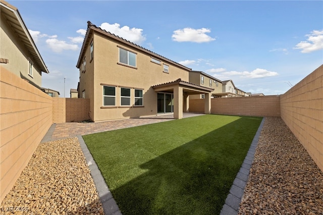 595 Beverly Pine Pl, Henderson, NV 89011 - rear view of property featuring a fenced backyard, stucco siding, a yard, and a patio area