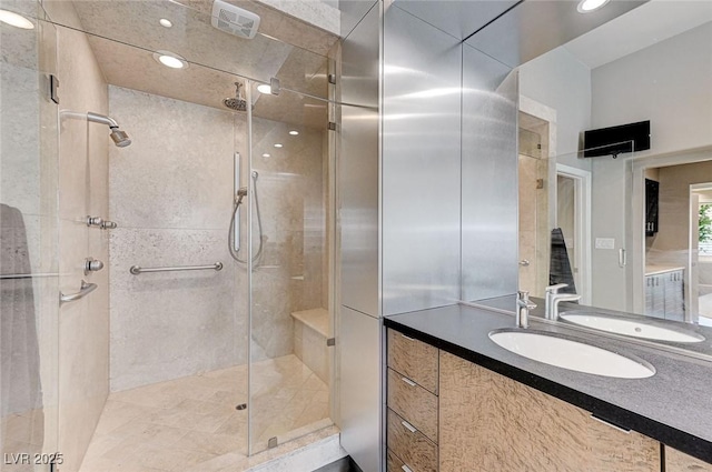bathroom featuring recessed lighting, a shower stall, and vanity