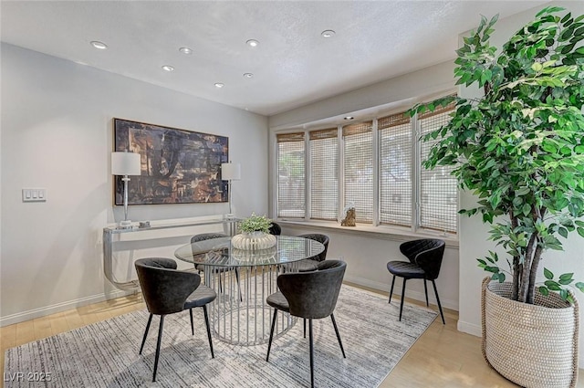 dining area featuring recessed lighting, baseboards, and wood finished floors