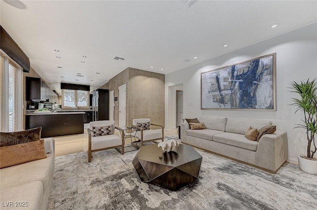 living room with recessed lighting and visible vents