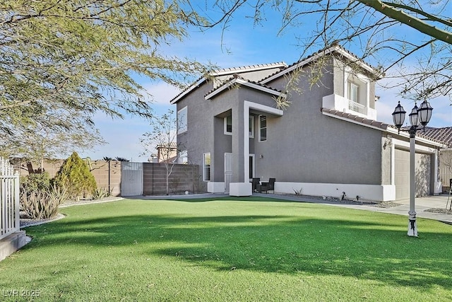 3738 Falcon Springs Dr, Las Vegas, NV 89147 - rear view of property with fence, stucco siding, a yard, and a tiled roof