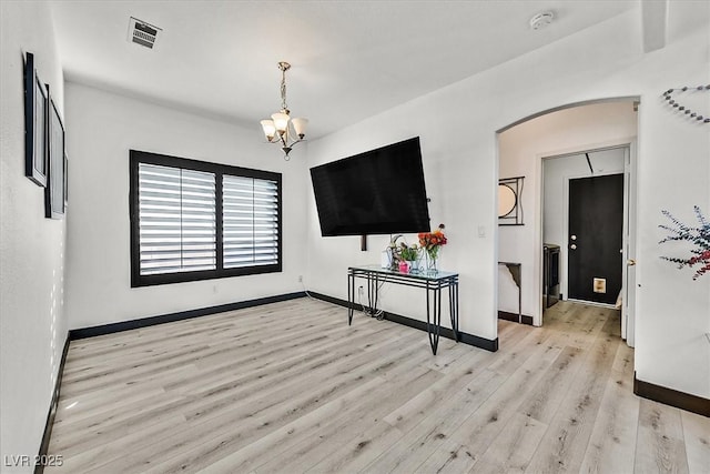 3738 Falcon Springs Dr, Las Vegas, NV 89147 - interior space featuring visible vents, arched walkways, baseboards, a notable chandelier, and light wood-style floors