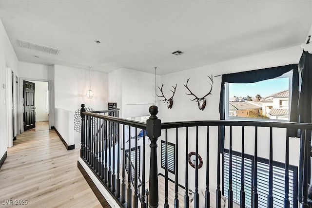 3738 Falcon Springs Dr, Las Vegas, NV 89147 - hall with baseboards, visible vents, an upstairs landing, and light wood-style floors