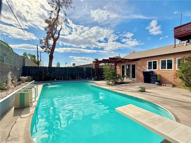 107 Elm St, Henderson, NV 89015 - view of pool with a diving board, a fenced in pool, a fenced backyard, and a patio area