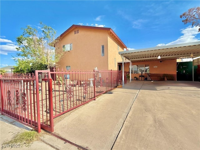 107 Elm St, Henderson, NV 89015 - view of side of property with concrete driveway, fence, and stucco siding