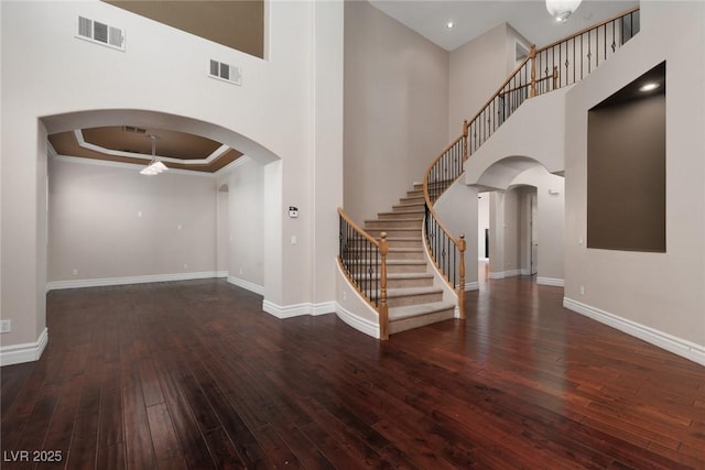7736 Villa Andrade Ave, Las Vegas, NV 89131 - entrance foyer featuring hardwood / wood-style flooring, baseboards, a high ceiling, stairway, and arched walkways