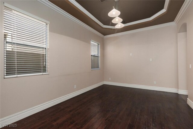 7736 Villa Andrade Ave, Las Vegas, NV 89131 - spare room with a tray ceiling, dark wood-style floors, baseboards, crown molding, and arched walkways