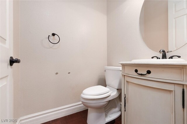 7736 Villa Andrade Ave, Las Vegas, NV 89131 - bathroom with toilet, vanity, baseboards, and wood finished floors