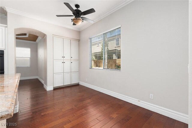 7736 Villa Andrade Ave, Las Vegas, NV 89131 - unfurnished bedroom featuring arched walkways, dark wood finished floors, baseboards, crown molding, and a closet