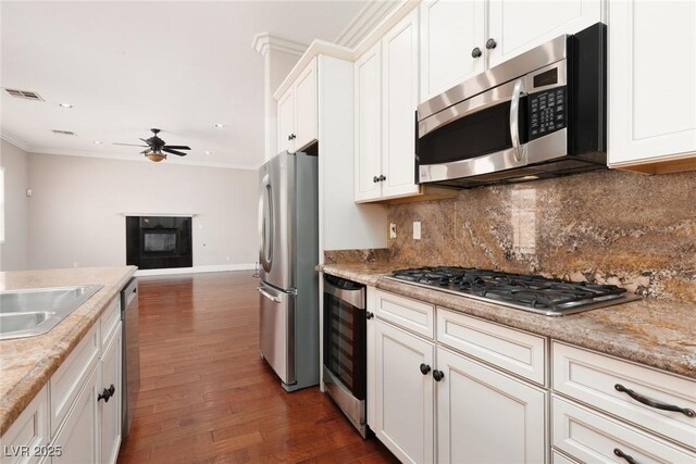 7736 Villa Andrade Ave, Las Vegas, NV 89131 - kitchen featuring stainless steel appliances, wine cooler, ceiling fan, dark wood-type flooring, and white cabinetry