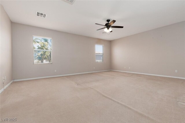 7736 Villa Andrade Ave, Las Vegas, NV 89131 - empty room featuring plenty of natural light, light carpet, a ceiling fan, and baseboards