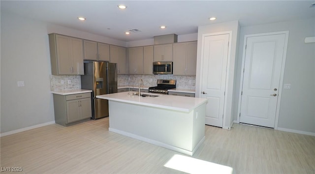 kitchen featuring gray cabinetry, appliances with stainless steel finishes, a sink, and visible vents