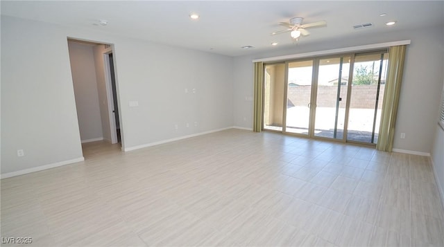 empty room with baseboards, a ceiling fan, and recessed lighting
