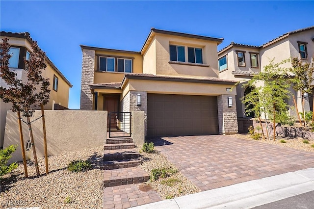 12101 Arrebol Ave, Las Vegas, NV 89138 - view of front facade with stucco siding, a garage, stone siding, a tiled roof, and decorative driveway
